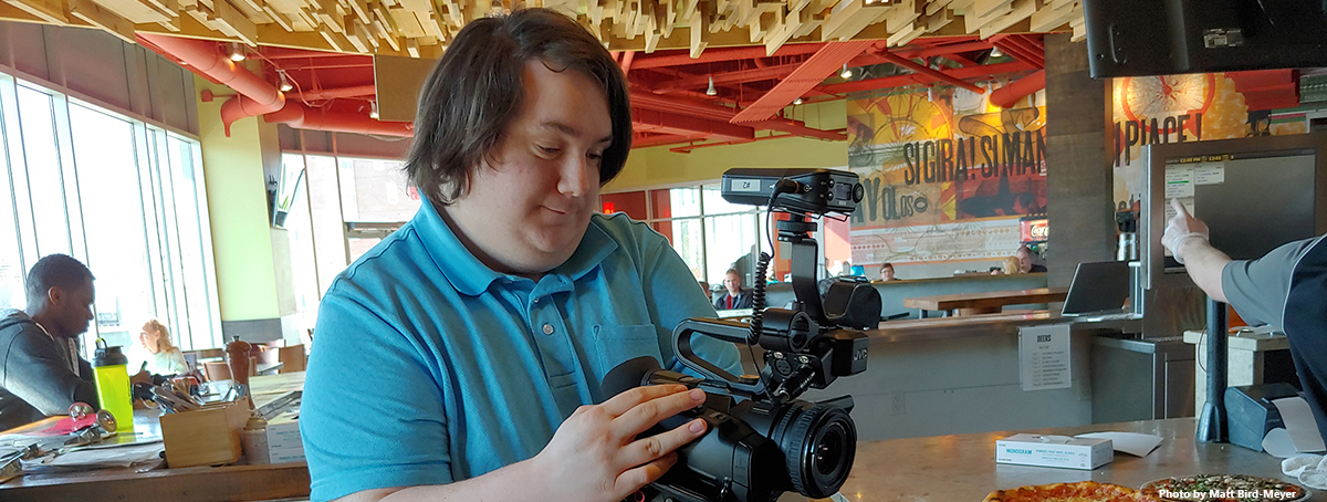 Garrett operating a video camera
